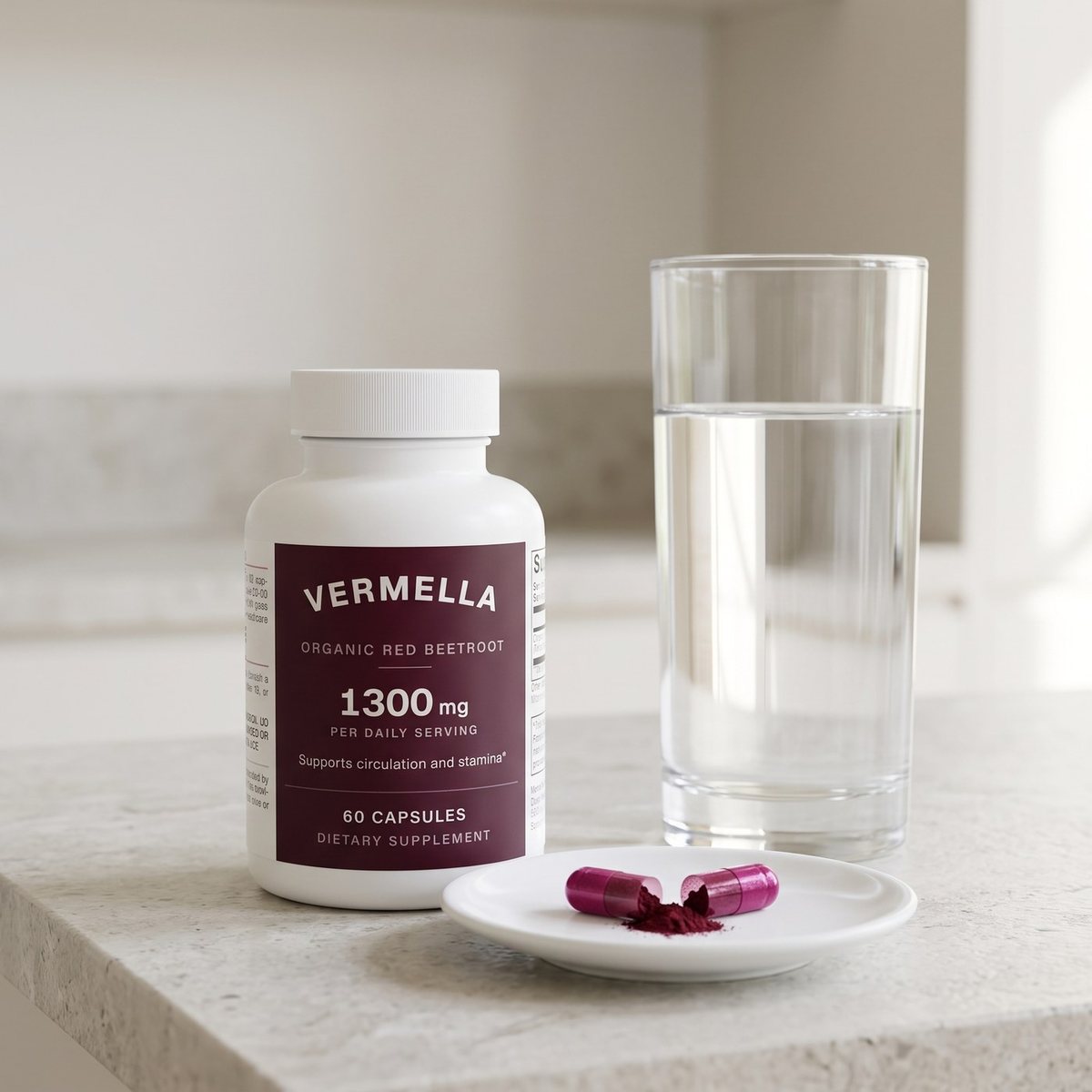 A bottle of Vermella Beetroot, a glass of water and two capsules on a saucer, one opened to show the powder.